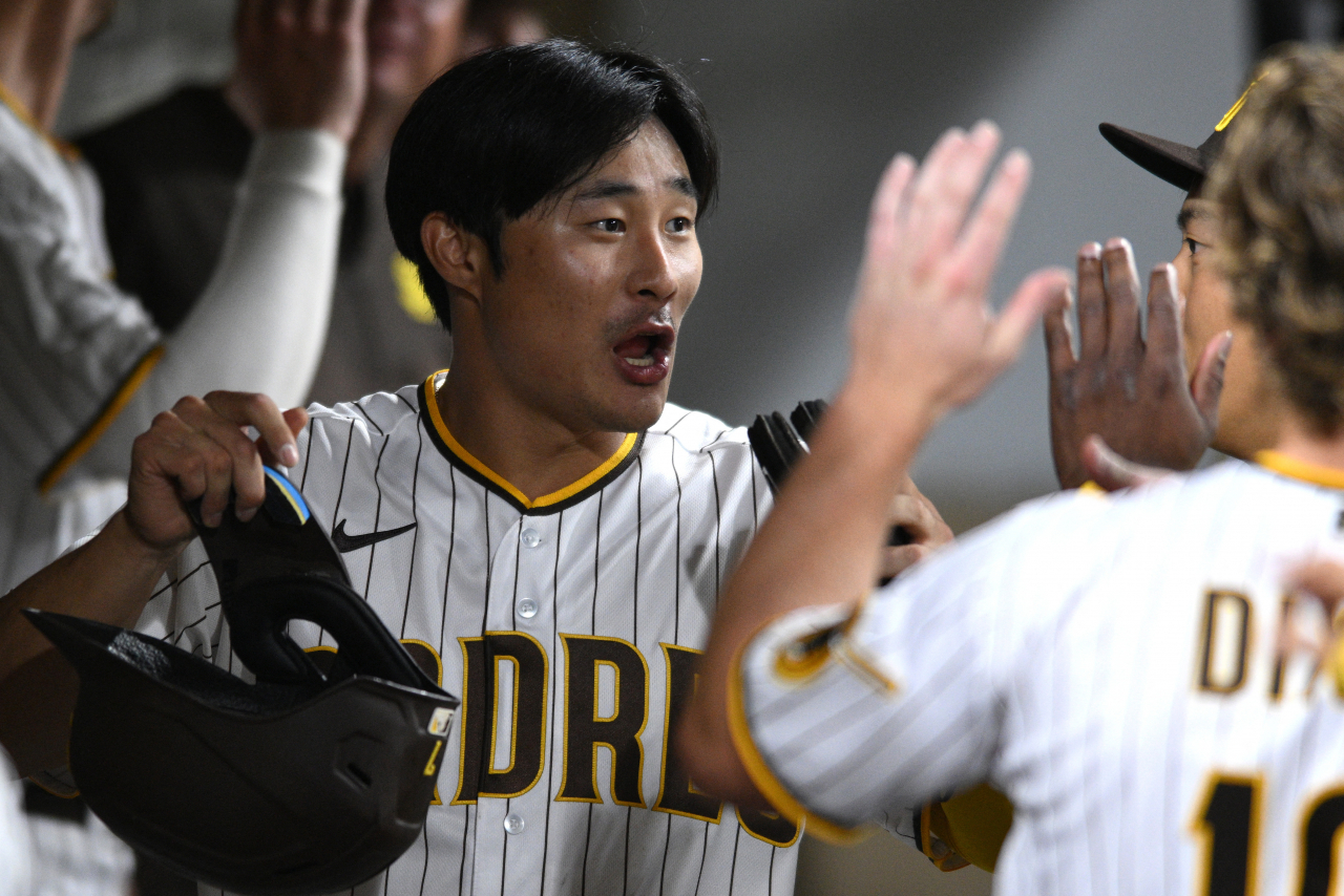 n this USA Today Sports photo via Reuters, Kim Ha-seong of the San Diego Padres celebrates with teammates in the dugout after scoring a run against the San Francisco Giants during the bottom of the sixth inning of a Major League Baseball regular season game at Petco Park in San Diego on Tuesday. (Reuters)
