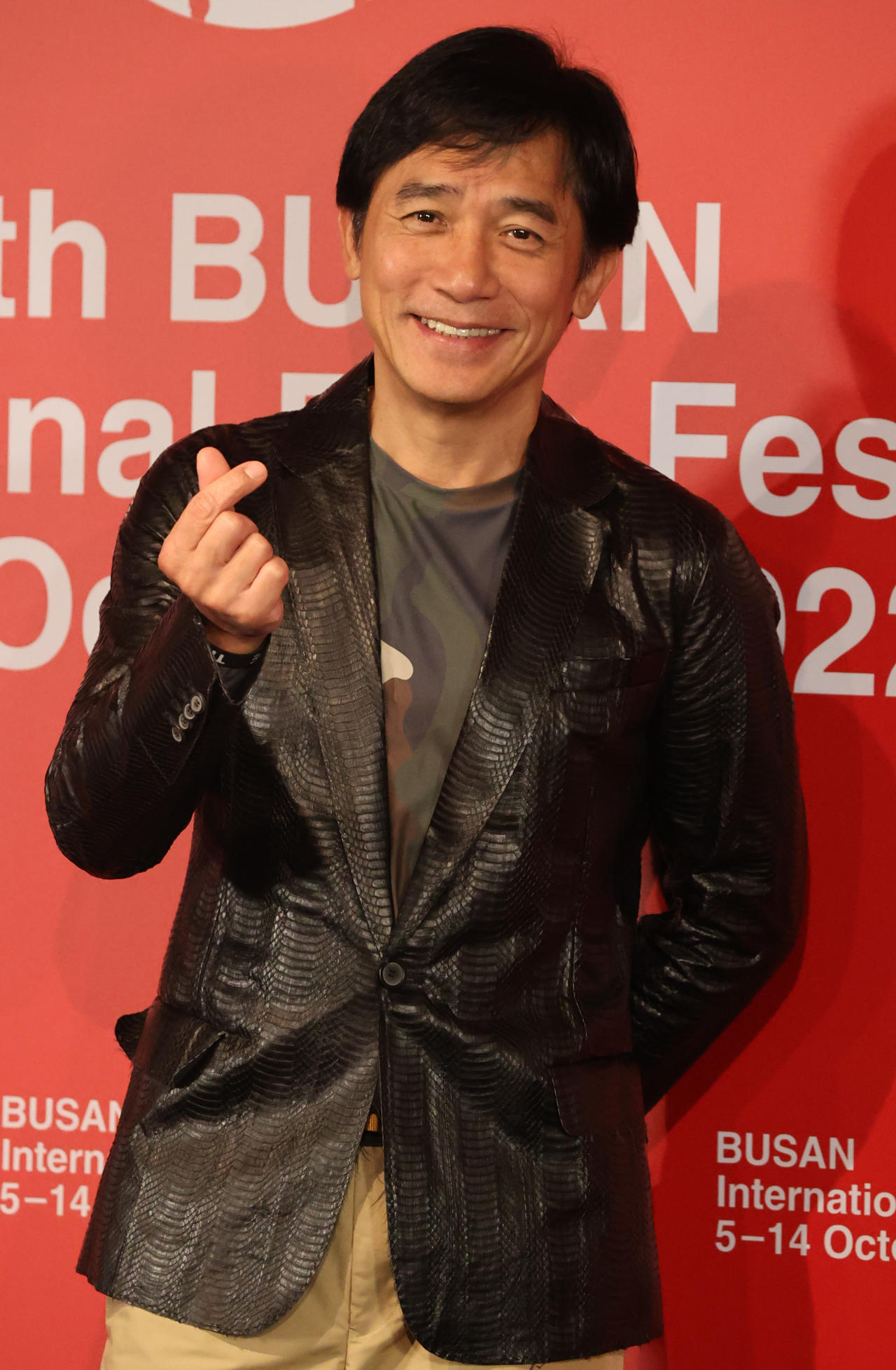 Hong Kong movie star Tony Leung poses for photos after a press conference held at the KNN theater in Busan, Thursday. (Yonhap)