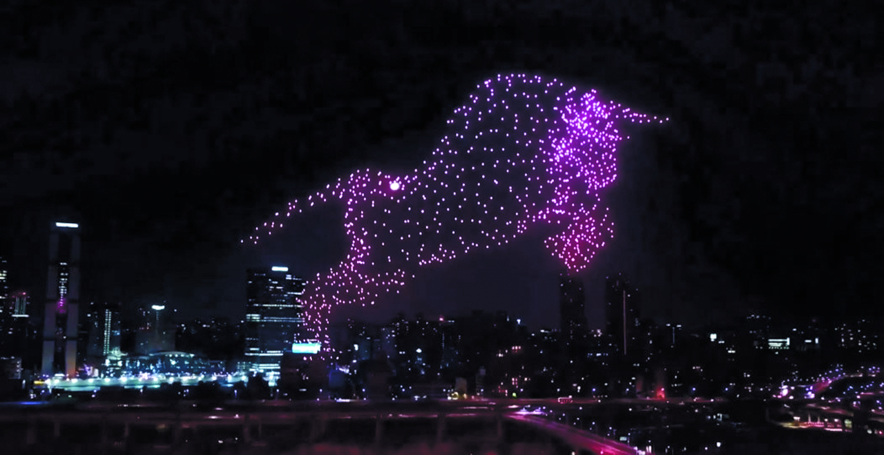 A total of 1,000 light-bearing drones form the shape of an ox in the night sky on Dec. 31. 2021, in a swarm drone show in Seoul prepared by UVify for Hyundai Motors. (UVify)