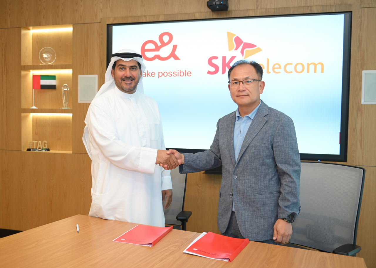 Khalifa Al Shamsi, CEO at e& life, and Ha Min-yong, chief development officer of SK Telecom, pose for a photo at the e& Group headquarters in Dubai, United Arab Emirates, Wednesday. (SK Telecom)