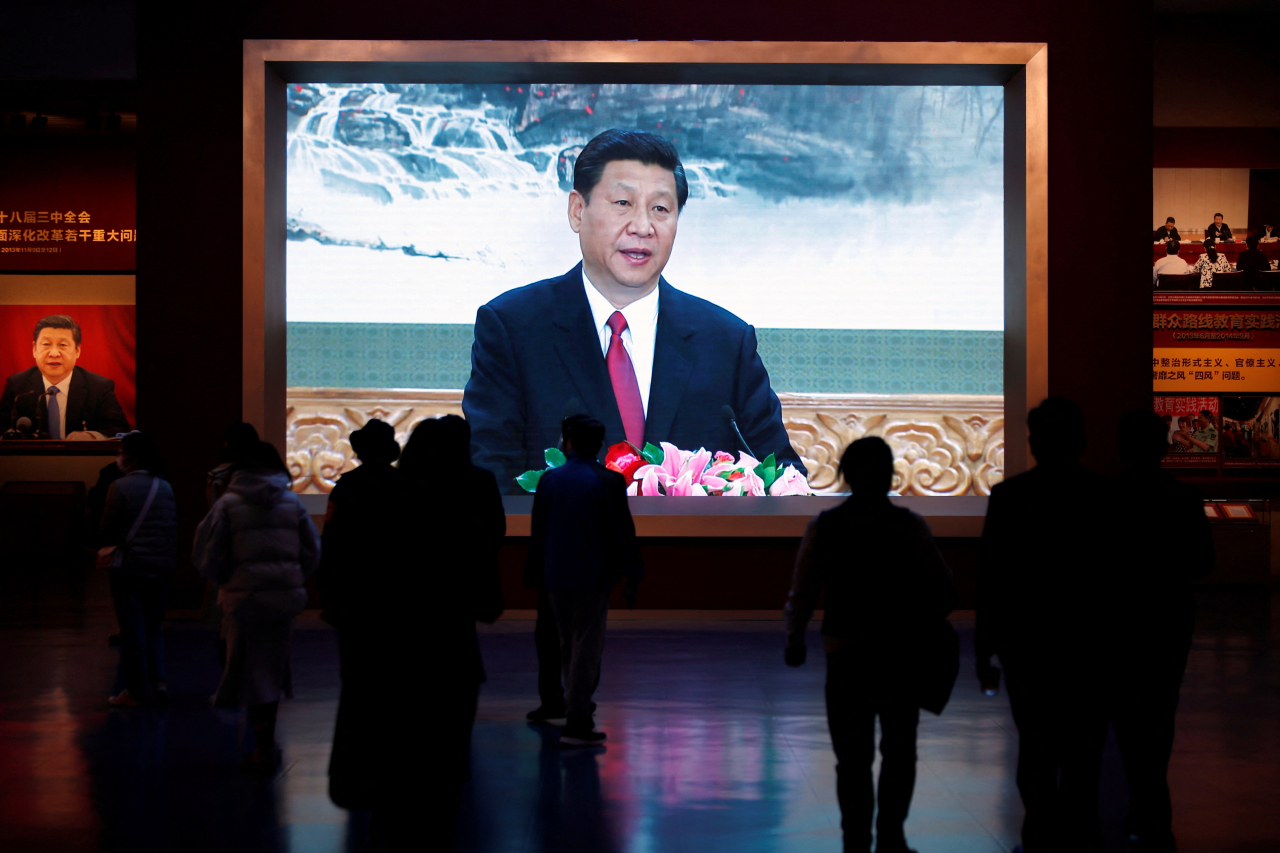 Visitors walk past a screen showing Chinese President Xi Jinping at the Museum of the Communist Party of China in Beijing, China on Thursday. (Reuters-Yonhap)