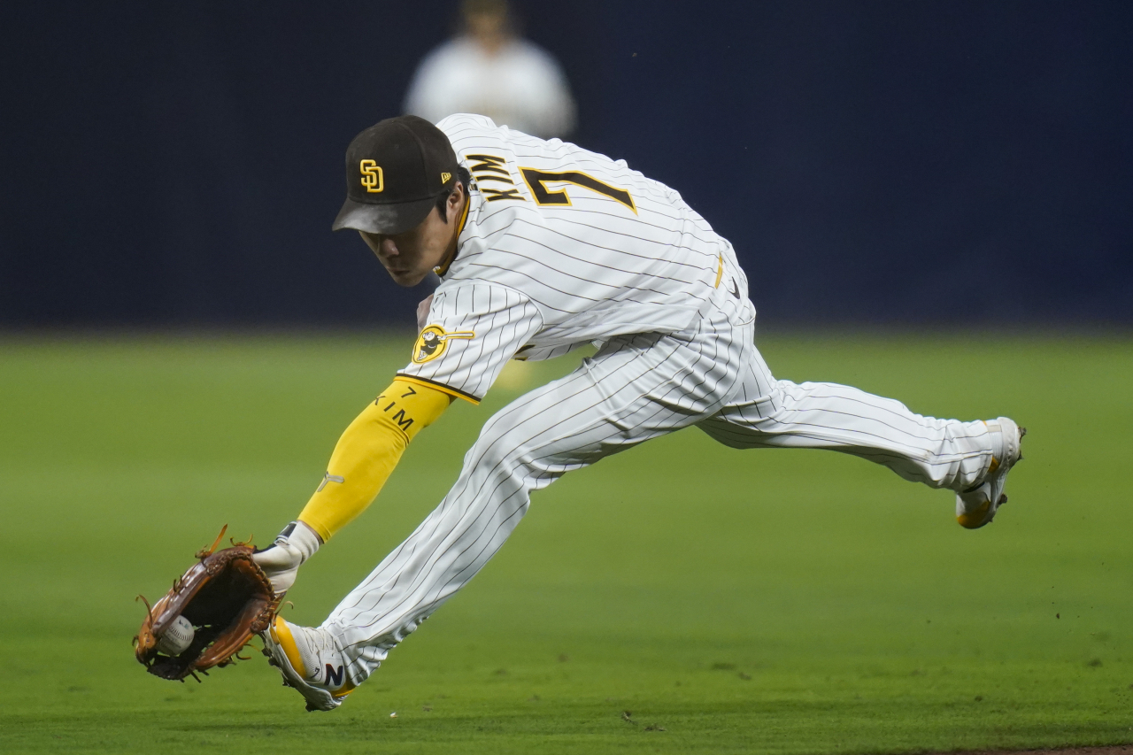 San Diego Padres shortstop Ha-Seong Kim reaches for a ground ball hit for a single by Los Angeles Dodgers' Justin Turner during the eighth inning in Game 3 of a baseball NL Division Series on Friday in San Diego. (AP Photo/Jae C. Hong)