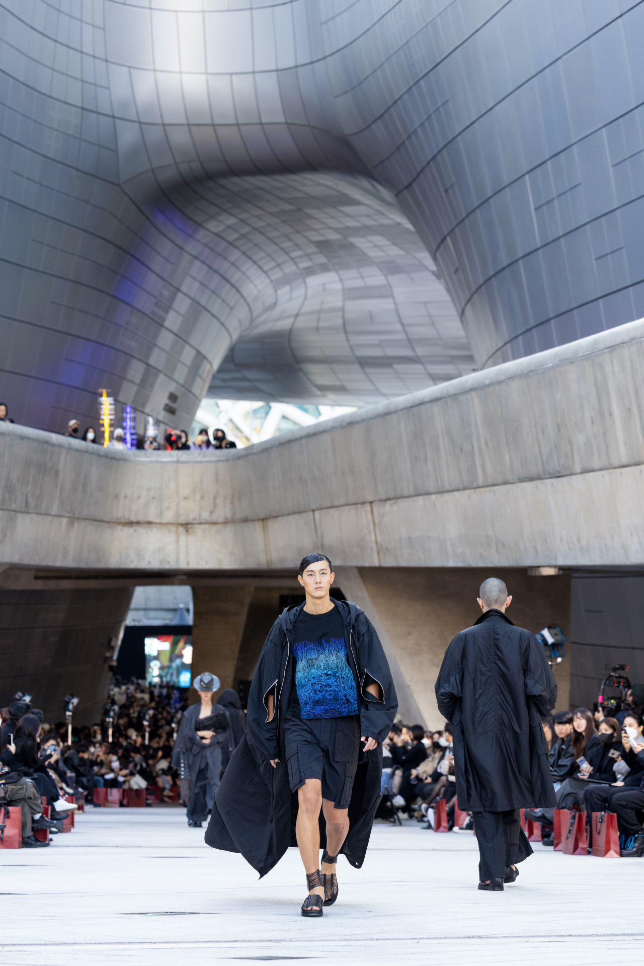 Models walk the 120-meter outdoor runway presenting Songzio's 2023 spring-summer collection Tuesday on the opening day of Seoul Fashion Week. (Seoul Fashion Week)
