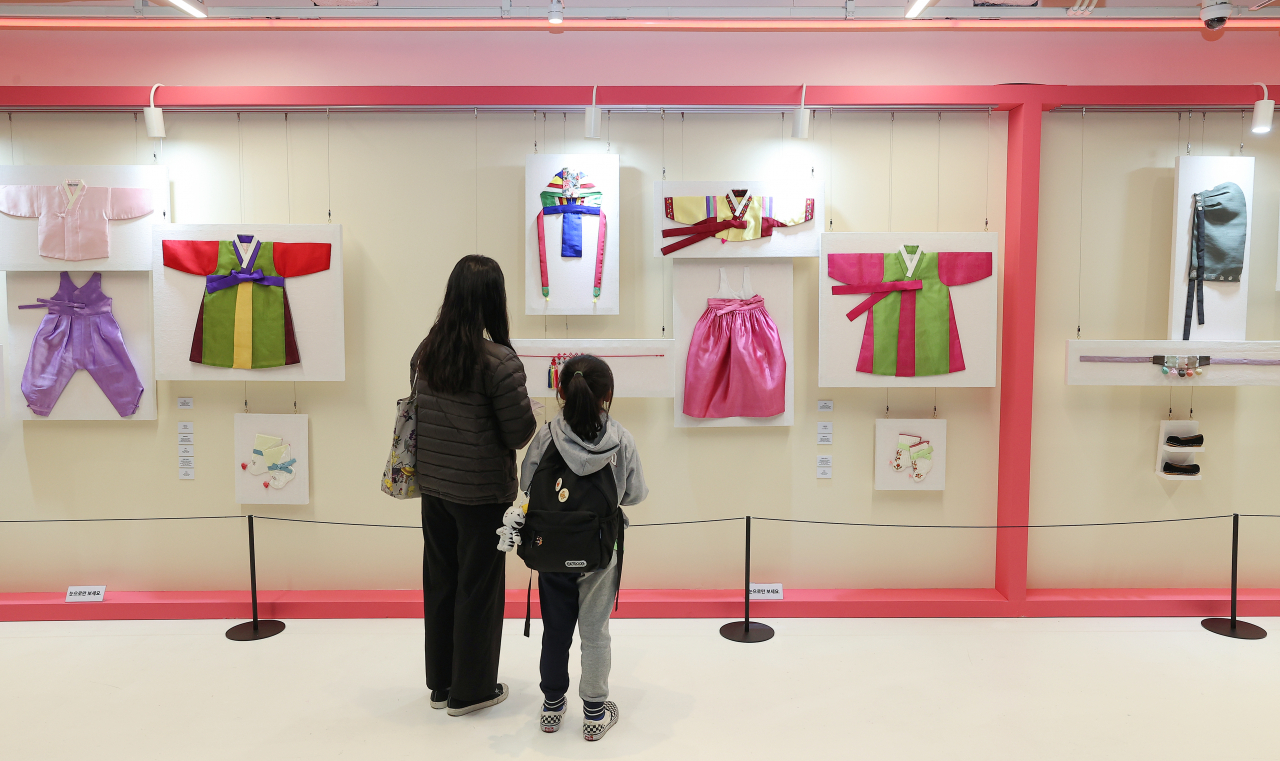 Visitors look at children's hanbok on display at HiKR Ground in central Seoul during 2022 Hanbok Culture Week, Monday. (Yonhap)