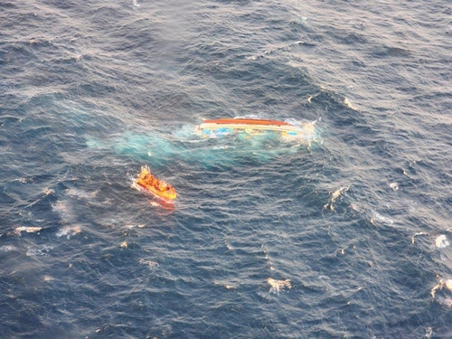 This photo provided by the Coast Guard's Jeju office shows a capsized boat in waters off Mara Island on Monday. (Yonhap)