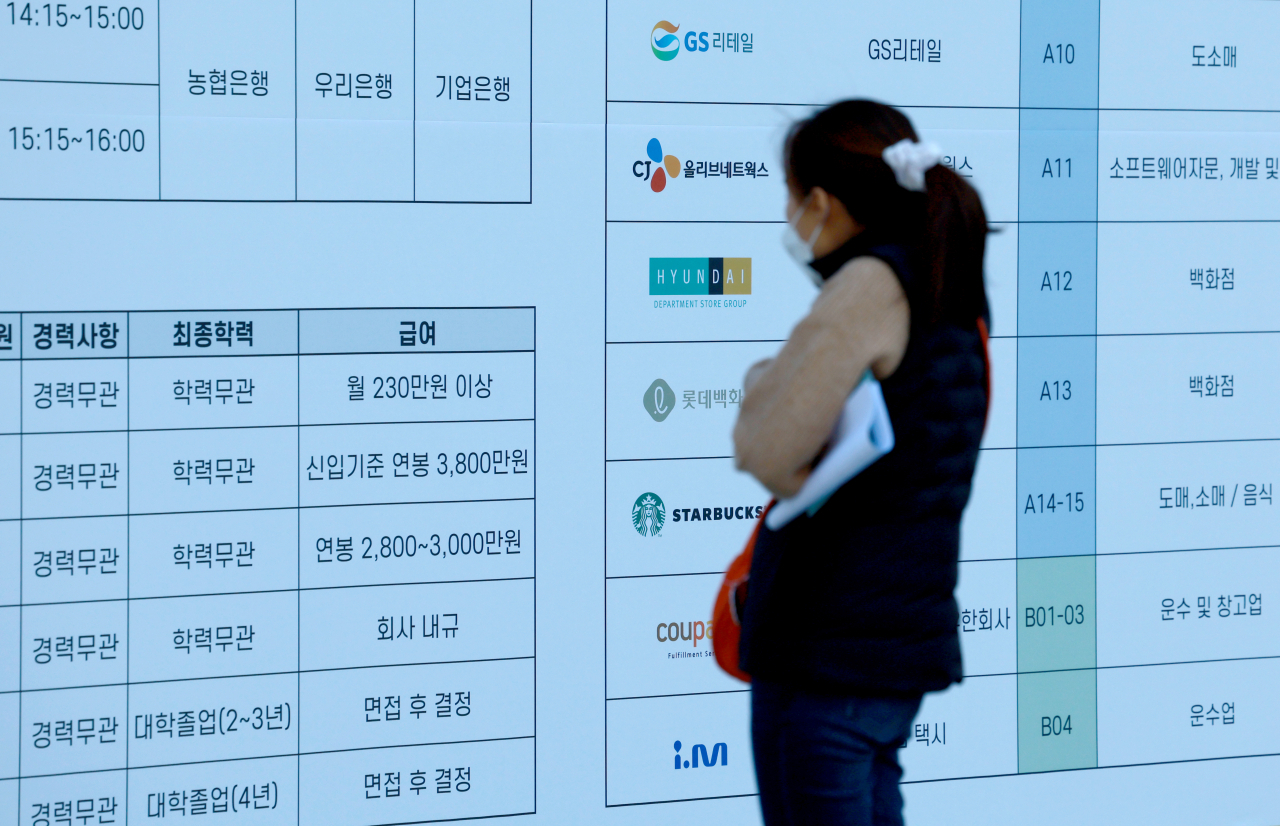 A woman looks at a wallposter with job listings at a job fair held in Gwanghwamun Square, Seoul, on Wednesday. (Yonhap)