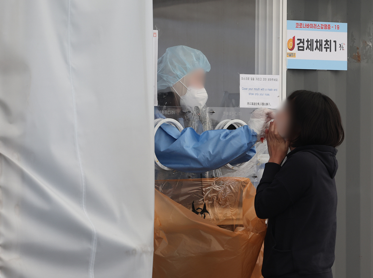 A person gets tested for COVID-19 at a testing center in Seoul on Wednesday. (Yonhap)