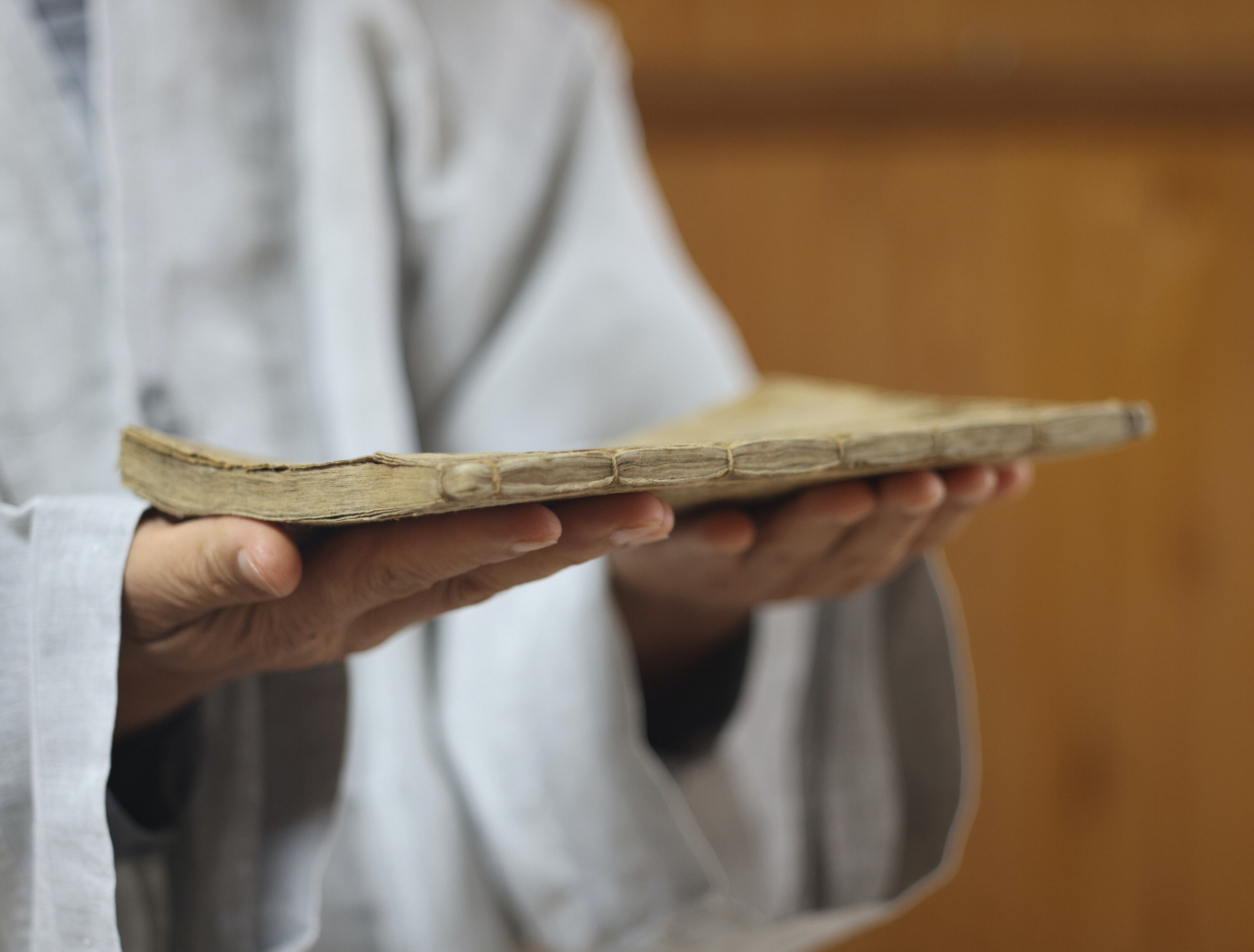 Ven.  Won-jin holds what is claimed to be the first extant Jeungdoga book printed with Goryeo movable metal type in Yangsan, South Gyeongsang Province.  (Photo © Hyungwon Kang)