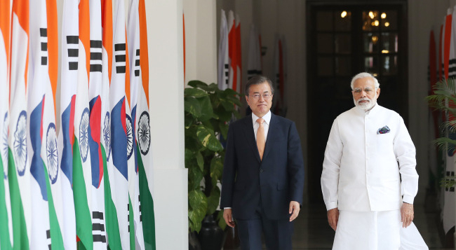 Former South Korean President Moon Jae-in (left) walks with Indian Prime Minister Narendra Modi during a state visit to India from July 8 to 11 in 2018. (Yonhap)