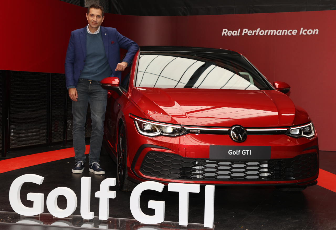 Sacha Askidjian, head of Volkswagen Korea, poses with the new Golf GTI at a launch event in Seoul on Tuesday. (Yonhap)