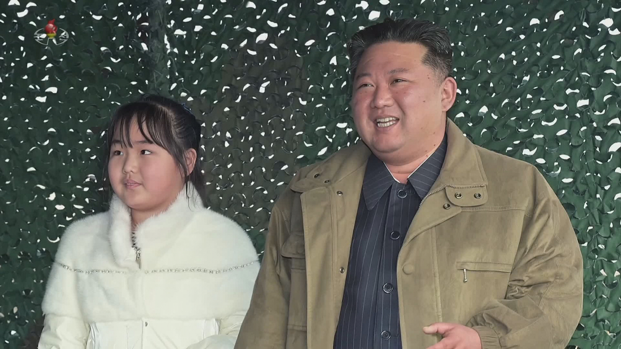 North Korean leader Kim Jong-un stands with his daughter at a missile launch site in this photo released by the Korean Central News Agency on Saturday. (Yonhap)