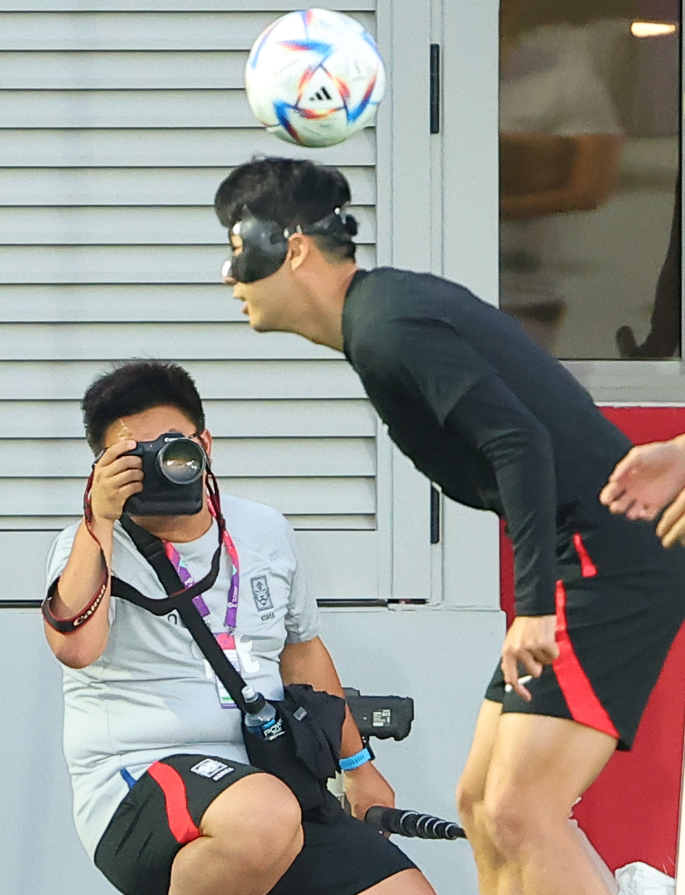 These composite photos show South Korean captain Son Heung-min heading the ball during a training session at Al Egla Training Site in Doha on Monday. (Yonhap)