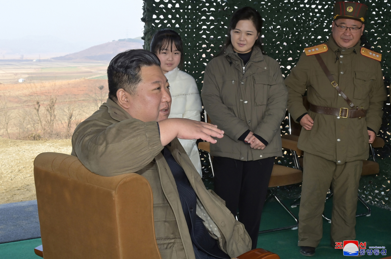 North Korean leader Kim Jong-un (right) inspects the launch of intercontinental ballistic missile Hwasong-17 on Friday, accompanied by his wife Ri Sol-ju (second from right) and their daughter Kim Ju-ae. (Yonhap)