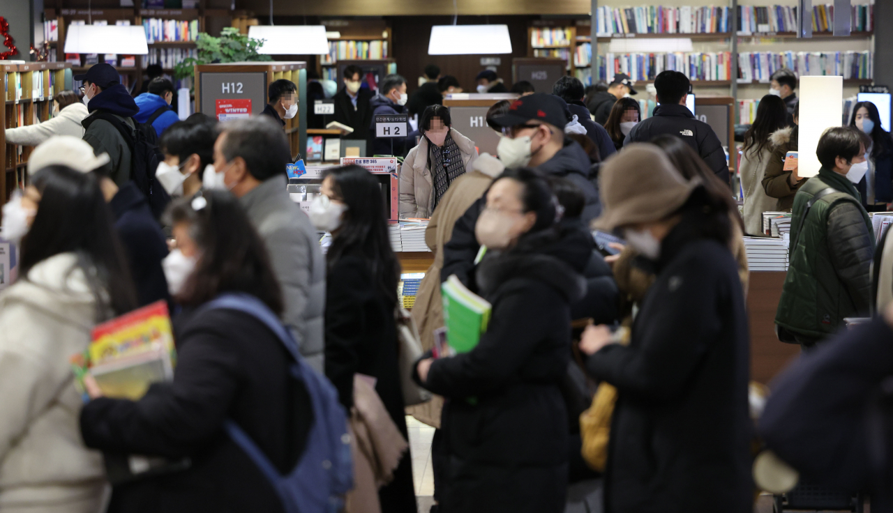 People are seen wearing face masks inside a book store in Seoul on Sunday. (Yonhap)