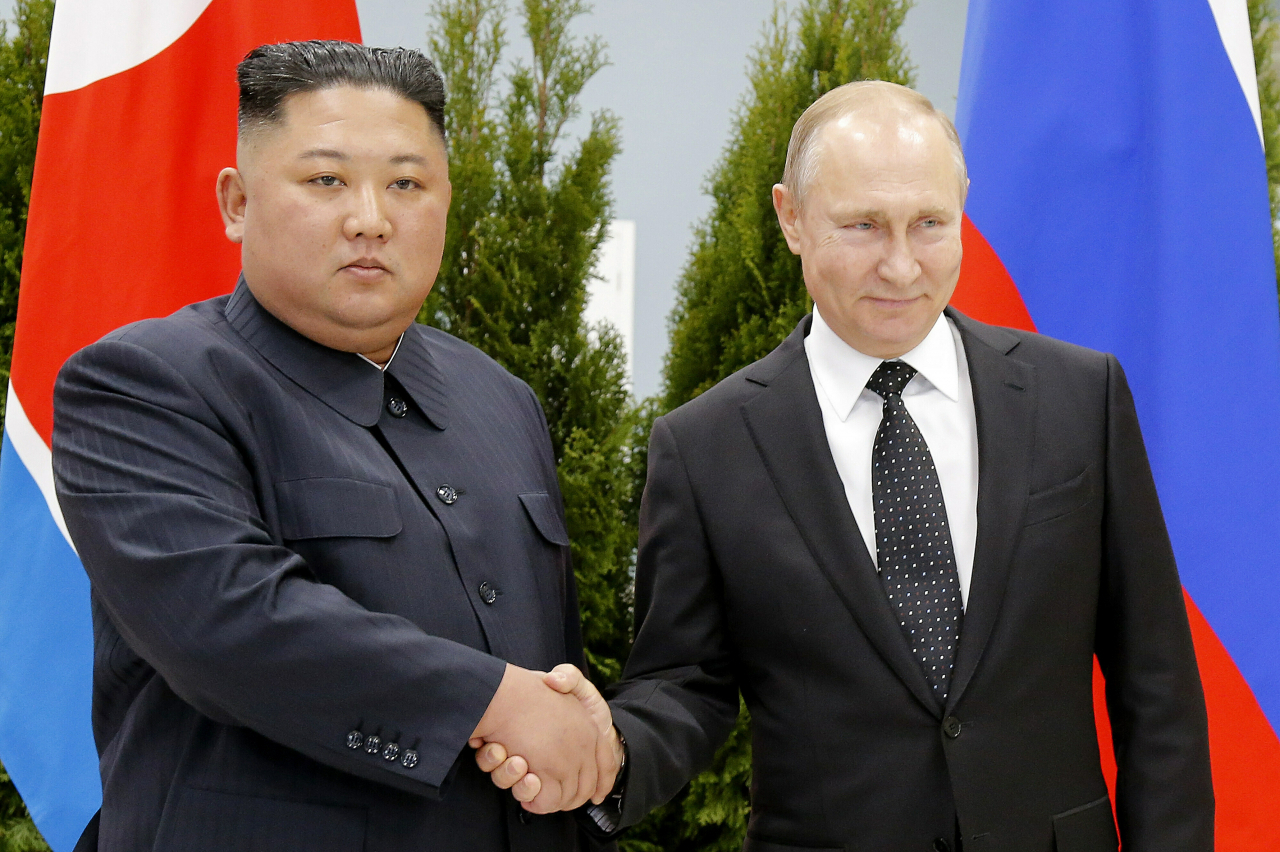 Russian President Vladimir Putin (right) and North Korea's leader Kim Jong-un shake hands during their meeting in Vladivostok, Russia on April 25, 2019. North Korea on November 8, 2022 accused the United States of cooking up a 