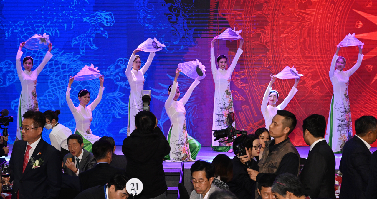 A Vietnamese traditional performance team dance in folk costumes on Friday. (Park Hae-mook/The Korea Herald)