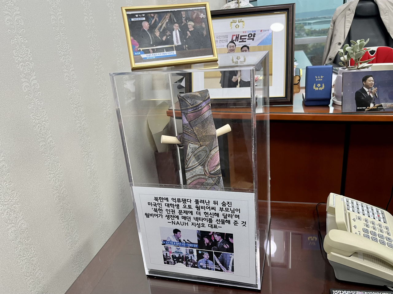 The necktie that belonged to Otto Warmbier, gifted to Ji by the late US student’s parents, hangs at the lawmaker’s office. Ji said he keeps it there as a reminder of what he has to do. (Kim Arin/The Korea Herald)