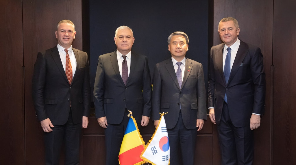 Defense Minister Lee Jong-sup (second from right) poses for a photo with his Romanian counterpart Angel Tilvar (second from left) as they hold talks in Seoul on Friday, in this photo provided by Lee's office. (Yonhap)