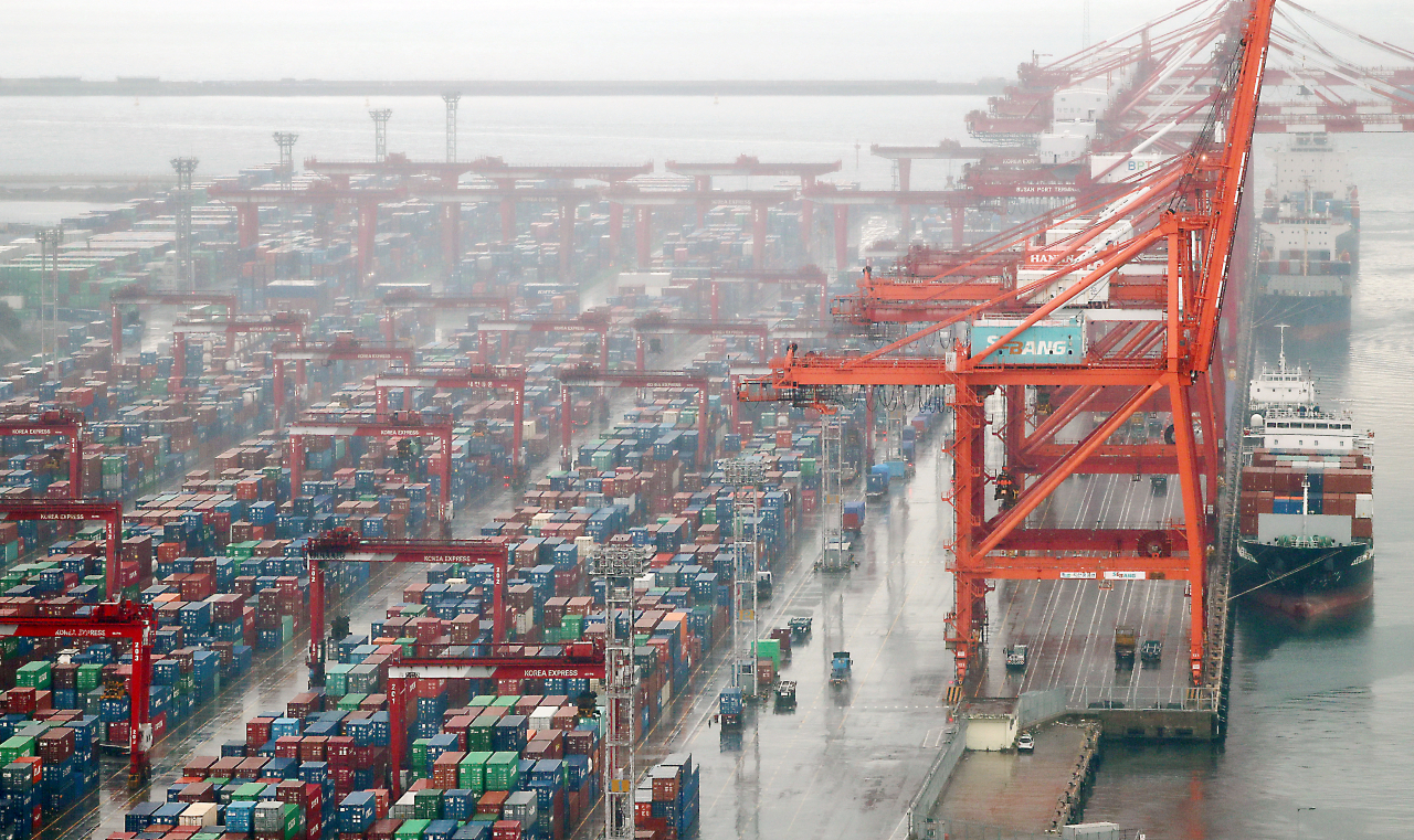 Cargo containers are stacked at a port in South Korea's southeastern city of Busan. (Yonhap)