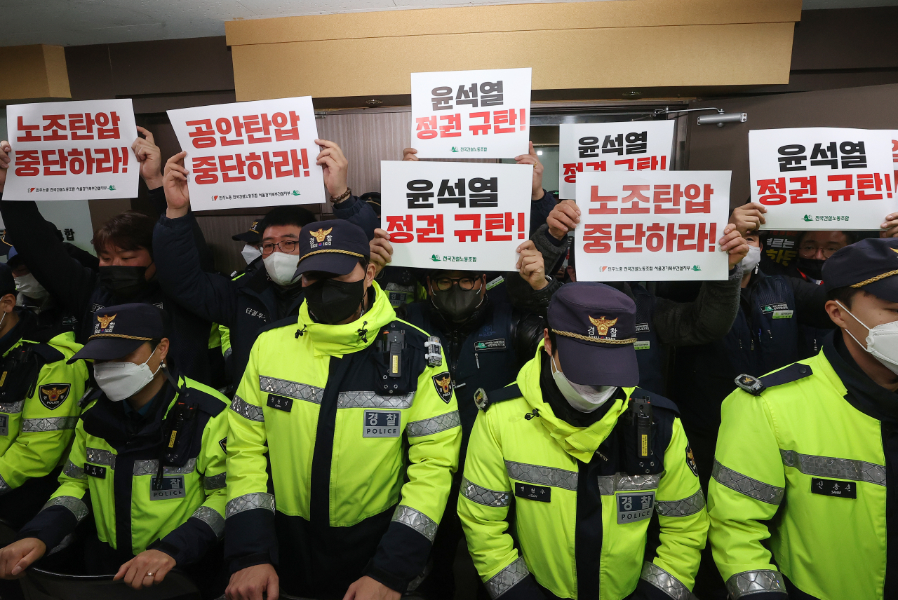 Members of the Korean Confederation of Trade Unions' construction union hold signs in front of its office in Yeongdeungpo-gu, Seoul, where a search is underway Thursday morning. The signs read 