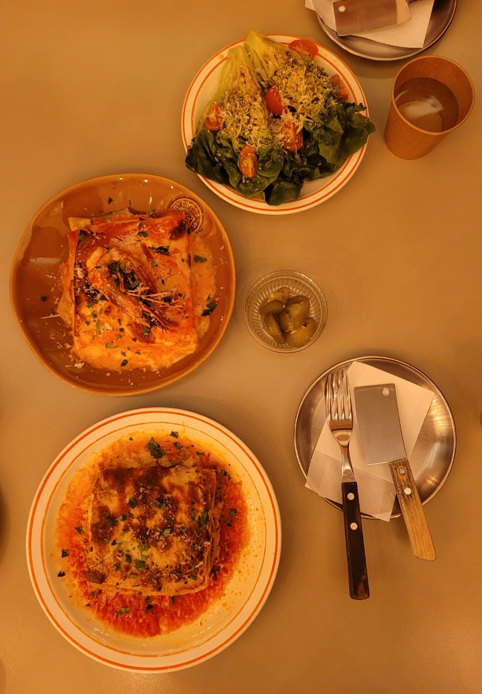 The house beef ragu lasagna, shrimp rose sauce lasagna and Romanian salad (Park Yuna/The Korea Herald)