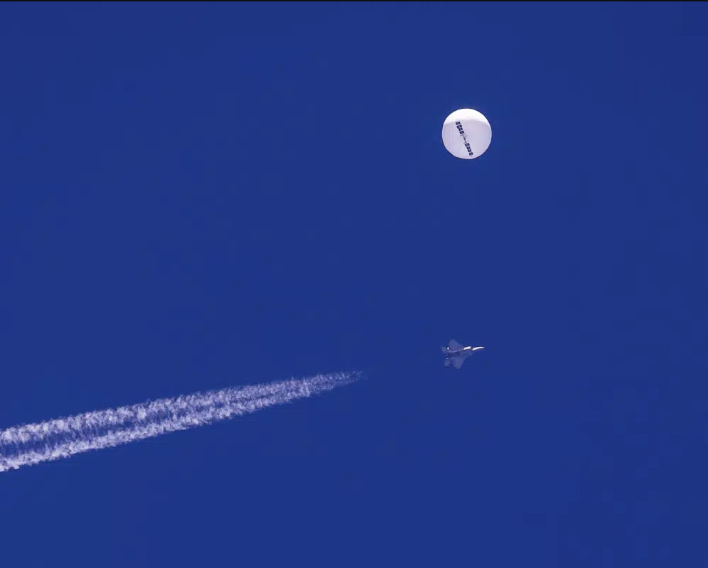 A large balloon drifts above the Atlantic Ocean, just off the coast of South Carolina, with a fighter jet and its contrail seen below it on Saturday. The balloon was struck by a missile from an F-22 fighter just off Myrtle Beach, fascinating sky-watchers across a populous area known as the Grand Strand for its miles of beaches that draw retirees and vacationers. (Chad Fish via AP)
