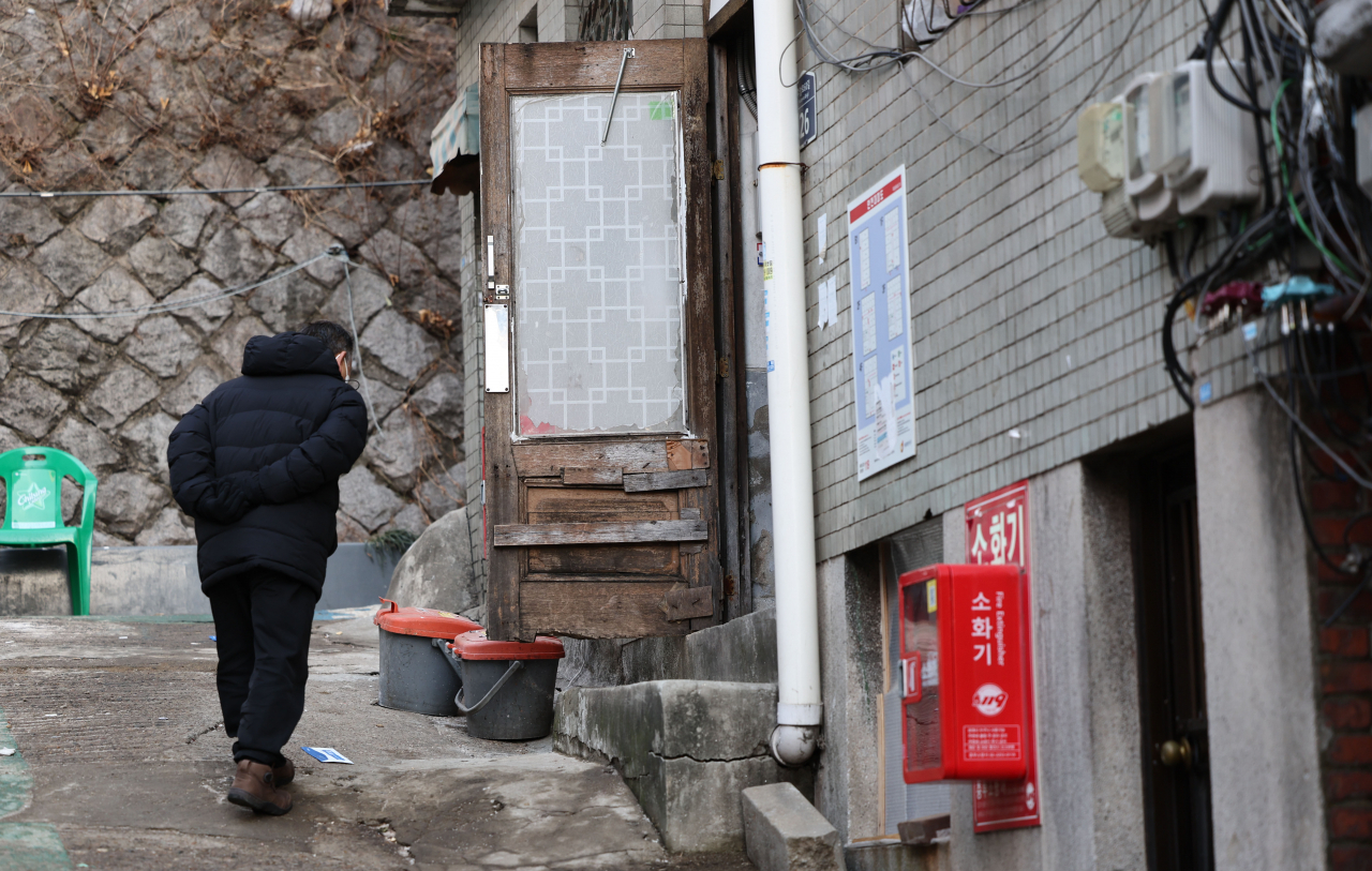 A man walks past a small lodging, known as “jjokbang,” in Seoul’s Jongno district on Feb. 1. (Yonhap)