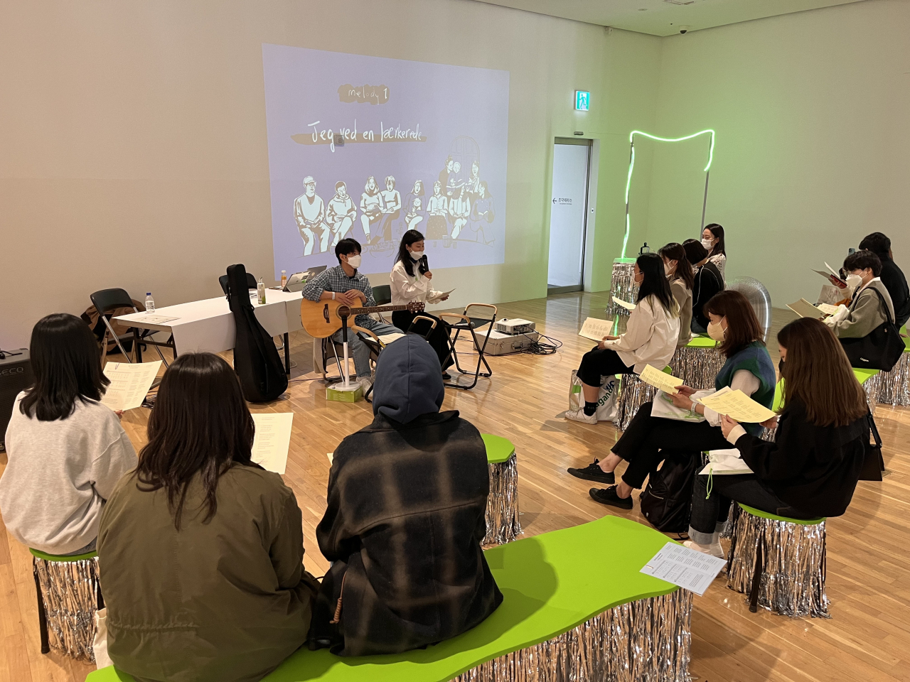 A group of people participate in a sing-along at Buk Seoul Museum of Art on Oct. 28, 2022. (Lee Hannah)