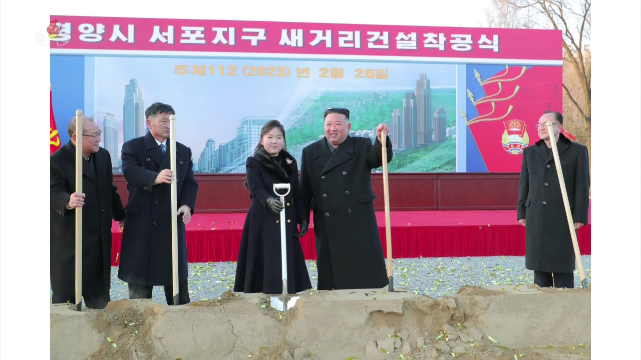 This photo, released by North Korea's official Korean Central News Agency on Feb. 26, shows North Korean leader Kim Jong-un (2nd from L) and his daughter Kim Ju-ae (C) attending a groundbreaking ceremony for a new street in Pyongyang the previous day. (Yonhap)