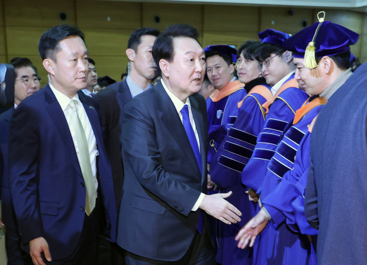 President Yoon Suk Yeol greets degree recipients after delivering a congratulatory speech at the graduation ceremony held at Yonsei University in Seoul on Monday. (Yonhap)