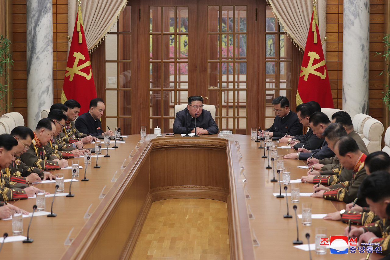 This photo, carried by North Korea`s official Korean Central News Agency on March 12, 2023, shows North Korean leader Kim Jong-un (C) presiding over a meeting of the Central Military Commission of the ruling Workers` Party of Korea, where the country has decided on 