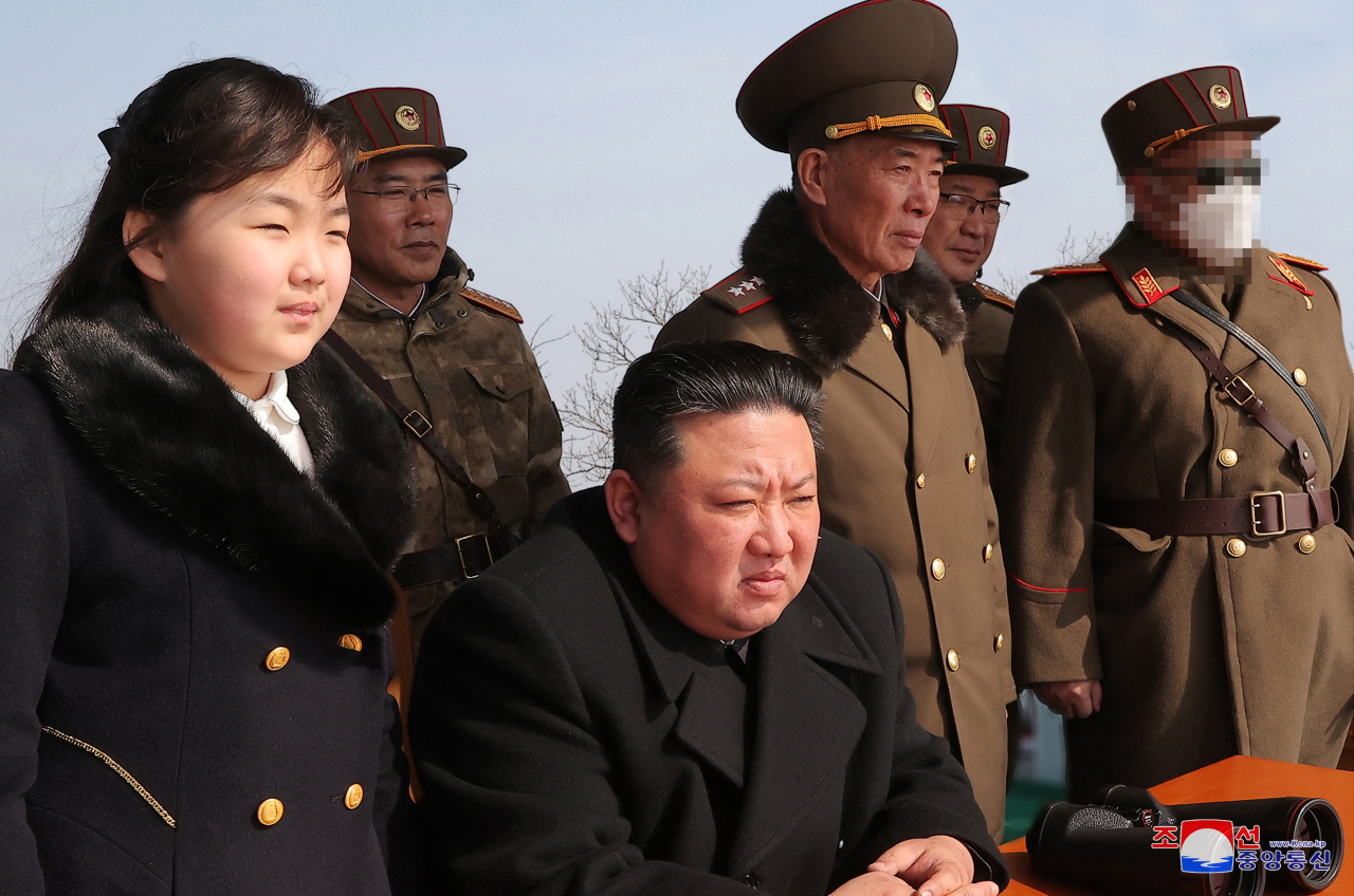 This photo, carried by North Korea`s official Korean Central News Agency (KCNA) on March 20, 2023, shows North Korean leader Kim Jong-un (sitting) and his daughter Ju-ae inspecting a combined tactical drill, which took place March 18-19, to bolster the country`s war deterrence and nuclear counterattack capability, in response to the ongoing South Korea-U.S. Freedom Shield joint drill. (Yonhap)