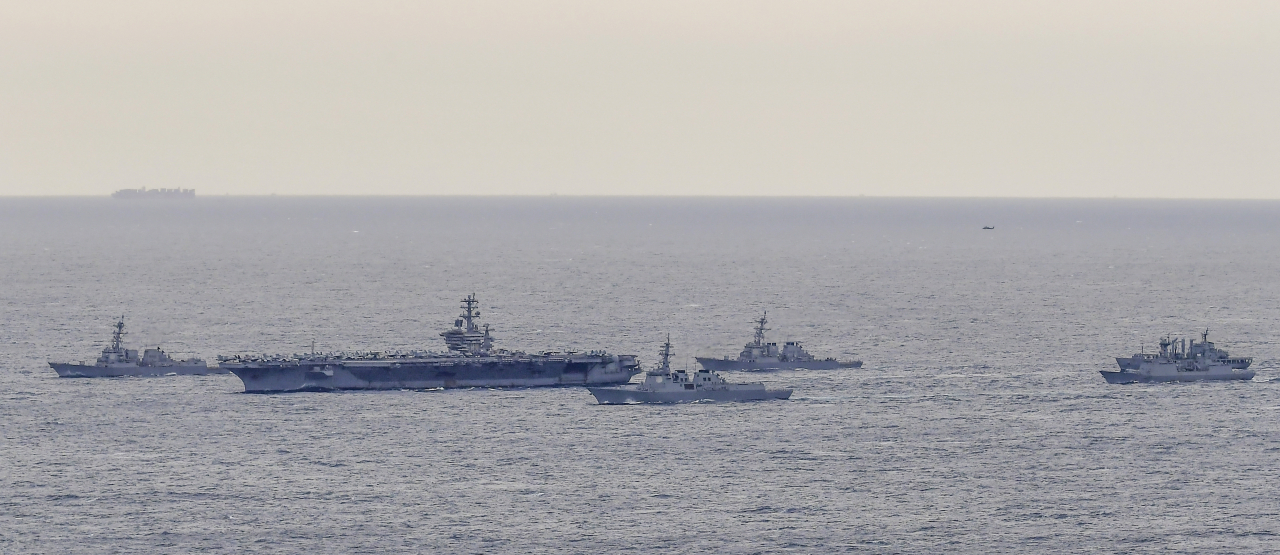 South Korean and US naval ships conduct a joint drill on seas off South Korea's southern Jeju Island, 465 kilometers south of Seoul, on March 27, 2023, in this photo provided by the South Korean Navy. The ships, from left to right, are USS Wayne Meyer, the aircraft carrier USS Nimitz, South Korea's 7,600-ton Sejong the Great, USS Decatur, and South Korea's 4,400-ton Choi Young and 4,200-ton Hwacheon. (Republic of Korea Navy)