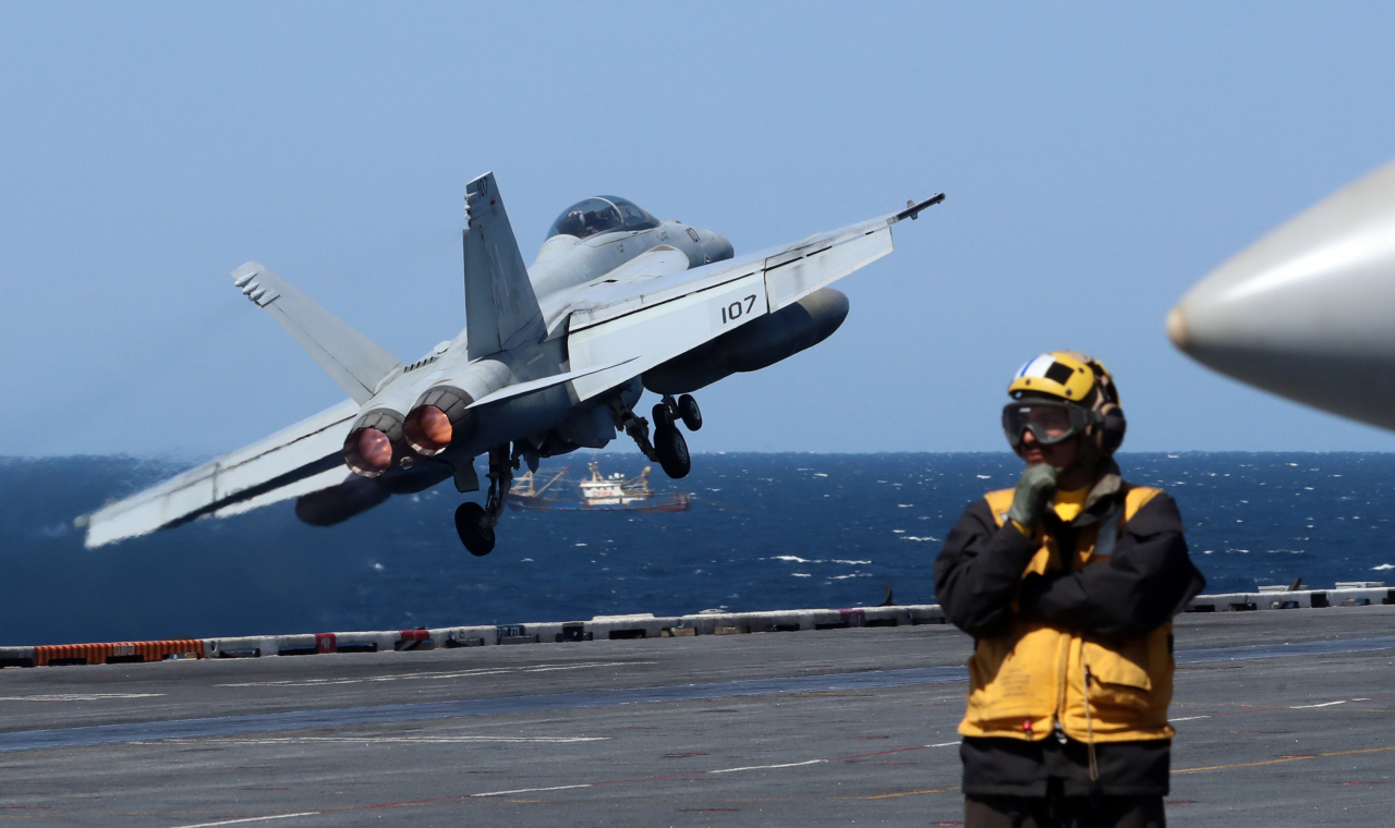A F/A-18F Super Hornet tactical aircraft takes off from the USS Nimitz (CVN 68), the US Navy's aircraft carrier, during combined maritime exercises between the South Korean and US Navies staged in the international waters south of Jeju Island on Monday. (South Korean Defense Ministry's Joint Press Corps)