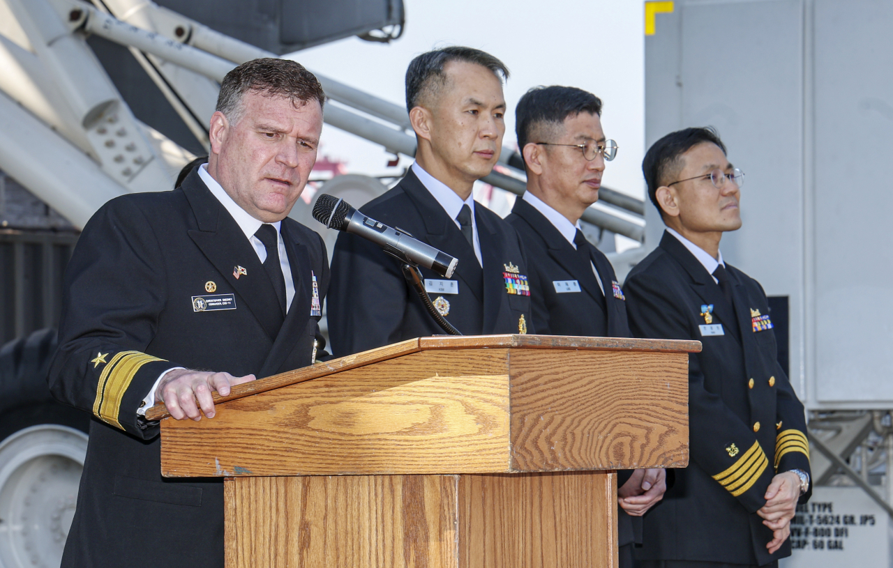 Rear Adm. Christopher Sweeney (Far Left), the commander of Carrier Strike Group 11, speaks during a South Korea-U.S. joint news conference aboard the USS Nimitz aircraft carrier at the South Korean naval base in Busan, 325 kilometers southeast of Seoul, on March 28, 2023. The nuclear-powered carrier entered the base earlier in the day for joint drills. (Pool photo) (Yonhap)