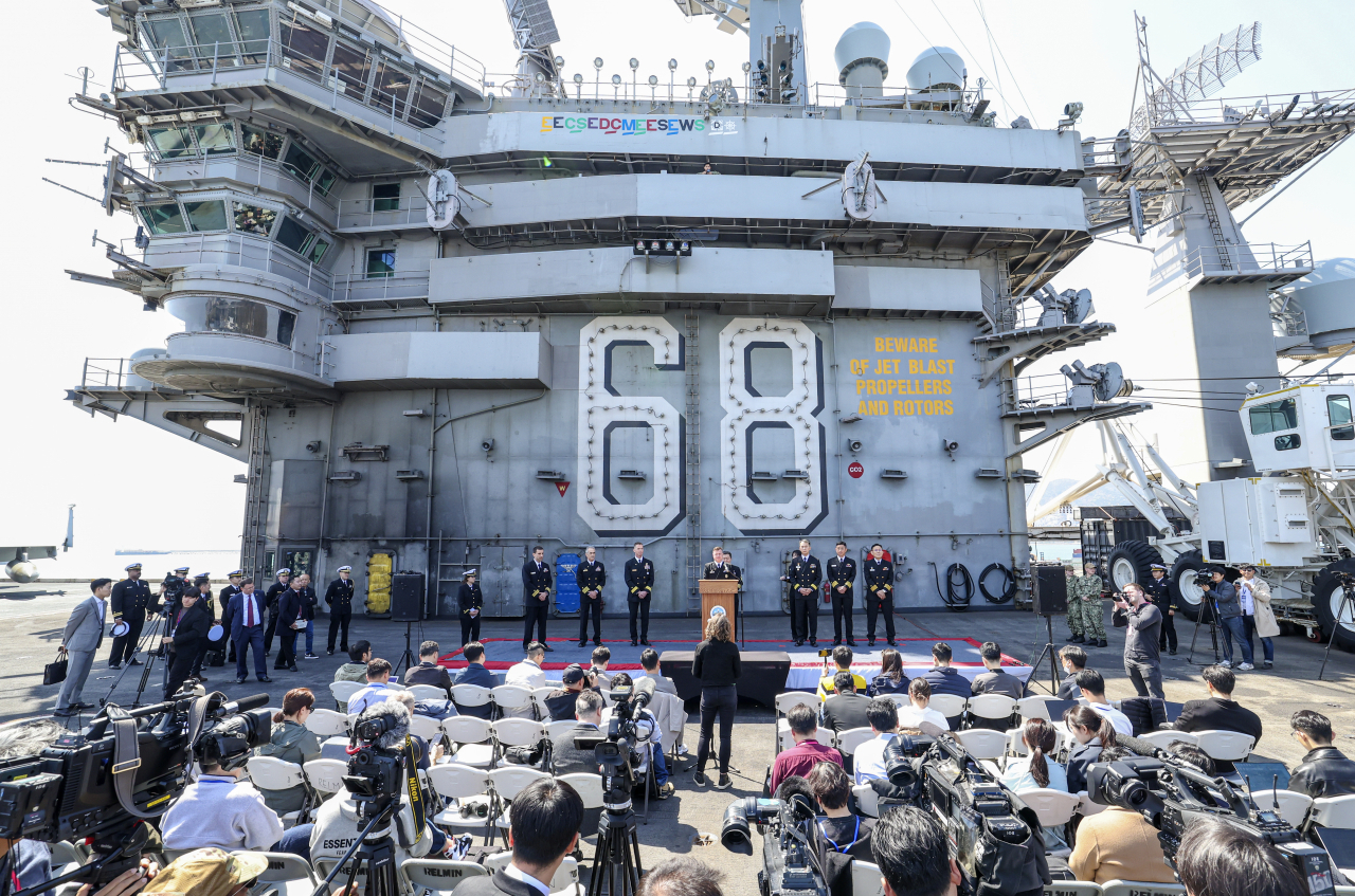 A South Korea-U.S. joint news conference takes place on the deck of the USS Nimitz aircraft carrier at the South Korean naval base in Busan, 325 kilometers southeast of Seoul, on March 28, 2023. The nuclear-powered carrier entered the base earlier in the day for joint drills. (Pool photo) (Yonhap)