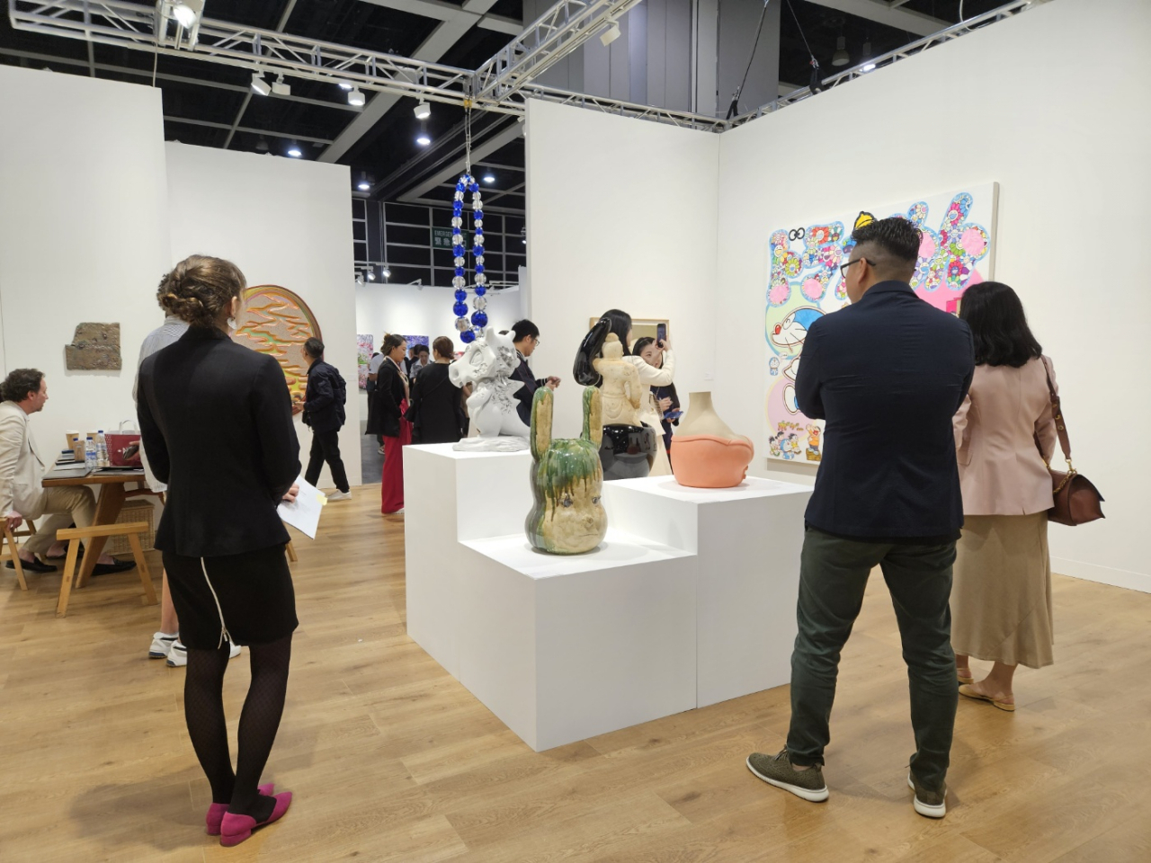 Fairgoers look around the Perrotin booth on March 21 at Art Basel Hong Kong, at the Hong Kong Convention and Exhibition Centre. (Park Yuna/The Korea Herald)