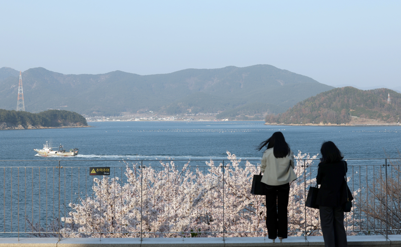 Visitors observe the view from the Tongyeong Concert Hall on Friday. (Yonhap)