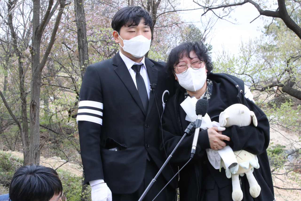 Daejeon school zone accident victim Bae Seung-ah's older brother (left) and mother holding Bae's beloved stuffed pig during an interview after Bae's funeral in Daejeon on Tuesday. (Yonhap)