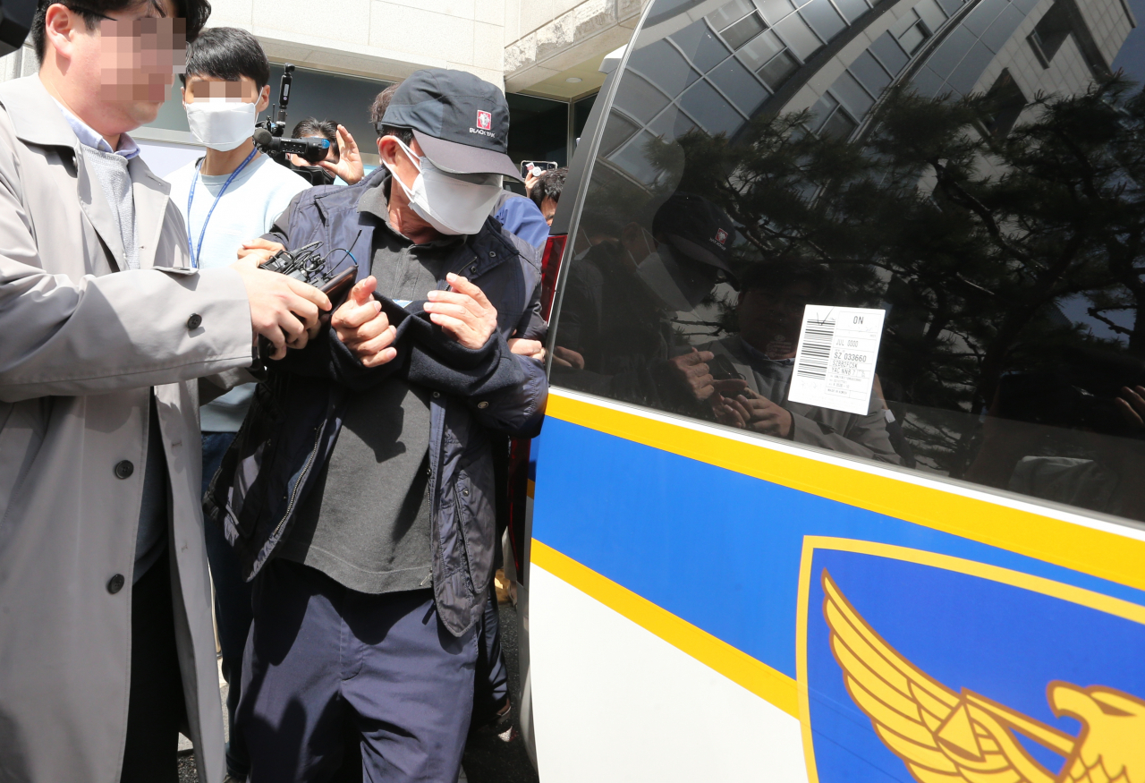 The suspect in the deadly Daejeon school zone crash is arrested by police in Daejeon on Monday. (Yonhap)