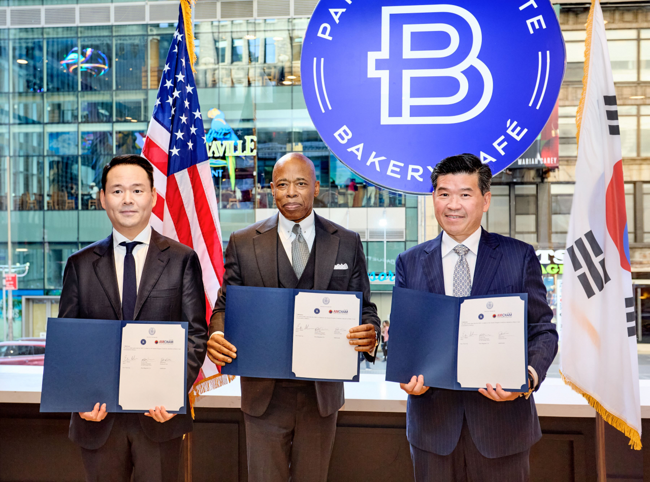 From left: Paris Baguette North America Chief Strategy Officer Hur Jin-soo, New York City Mayor Eric Adams and Chairman of the American Chamber of Commerce in Korea James Kim pose for a picture at a signing ceremony of their new partnership held in New York, Wednesday. (SPC Group)
