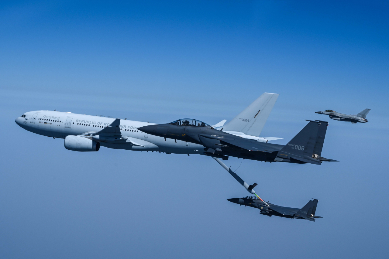 A KC-330 aerial tanker of the South Korean Air Force refuels an F-15K fighter jet in midair on April 12. (Republic of Korea Air Force)