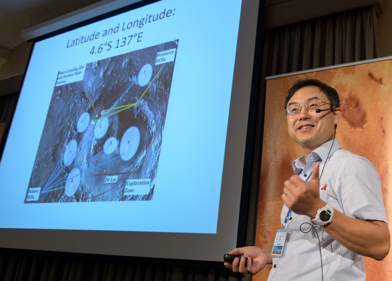Paul Yun, a mathematics professor at El Camino College and Korean American solar system ambassador of NASA, speaks during the First Landing Site/Exploration Zone Workshop for Human Missions to the Surface of Mars held at the Lunar and Planetary Institute on Oct. 28, 2015, in Houston. (NASA)