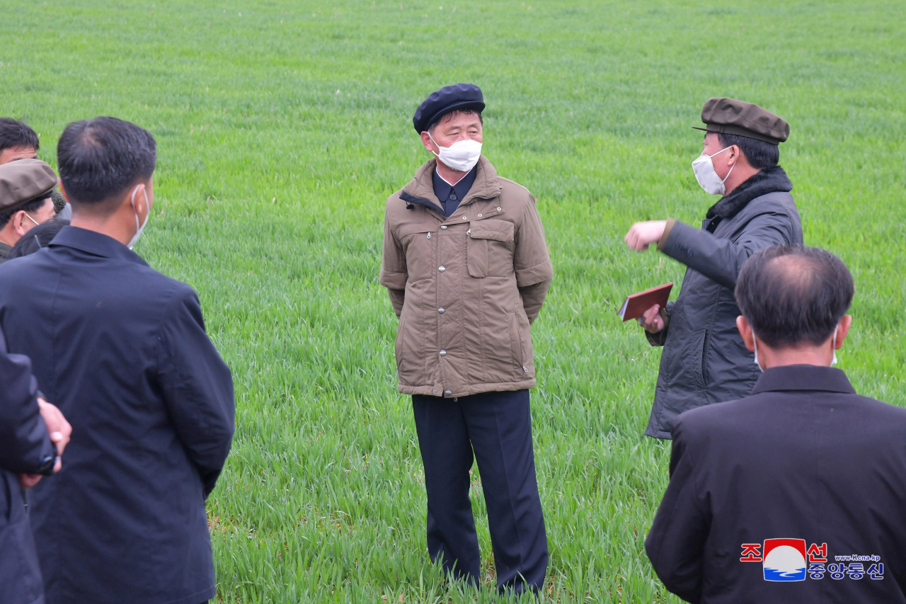 North Korean Premier Kim Tok-hun (center) inspects a farm in Pyongan Province, in this undated photo released by the North's official Korean Central News Agency on April 11. (Yonhap)
