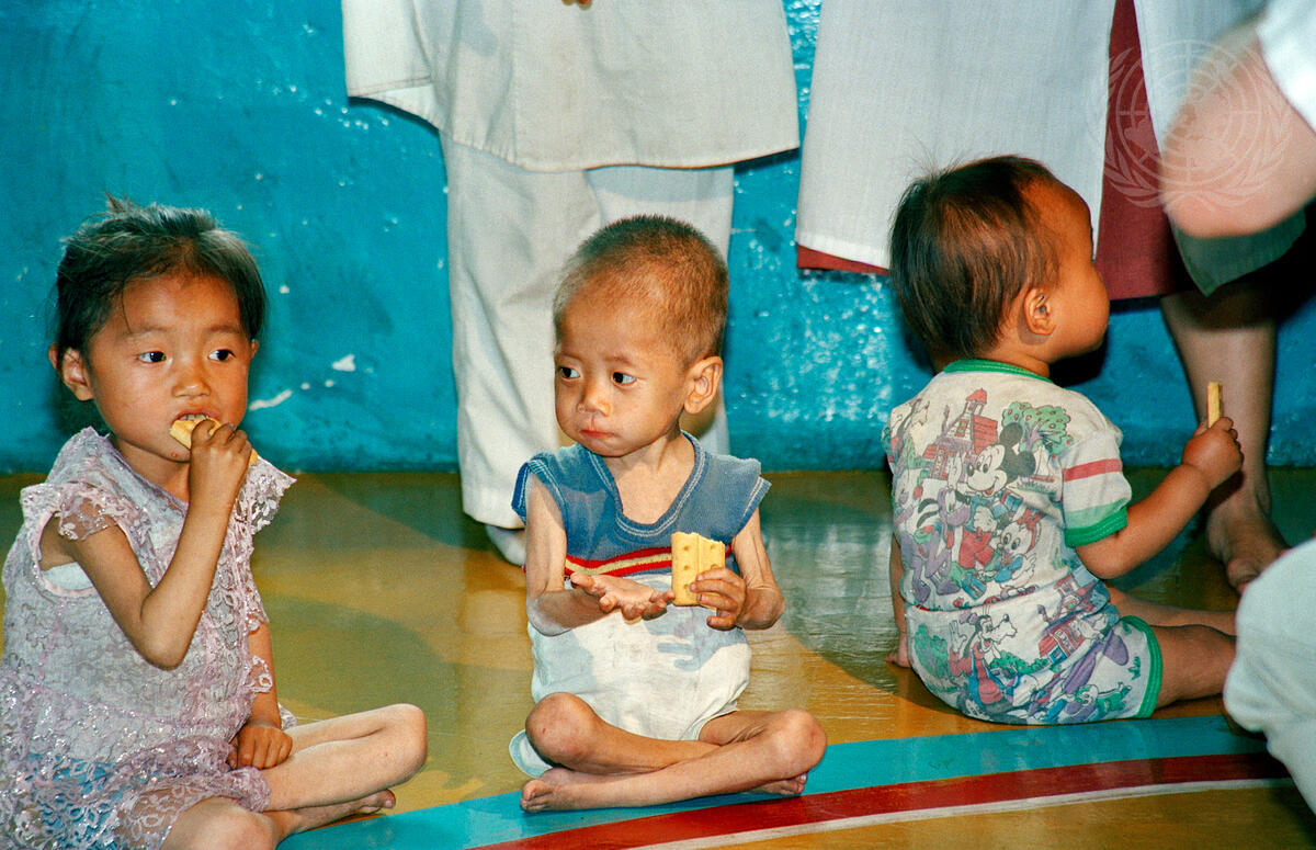 Malnourished nursery schoolchildren in a village northwest of Pyongyang, North Korea eat food rations. The photo was taken during a trip to the country by Yasushi Akashi, undersecretary-general for humanitarian affairs and emergency relief coordinator in 1997 to assess the impact of flood damage on the population, particularly children. (File Photo - United Nations)