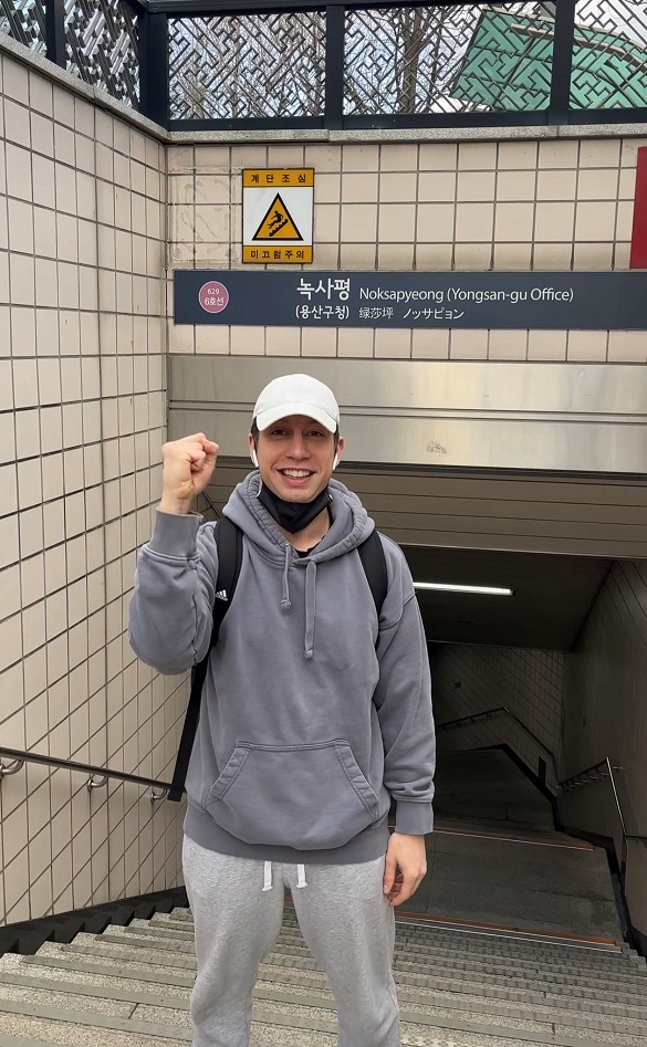 Jonah Aki poses for a photo in front of a Noksapyeong Station exit. (Courtesy of Aki)