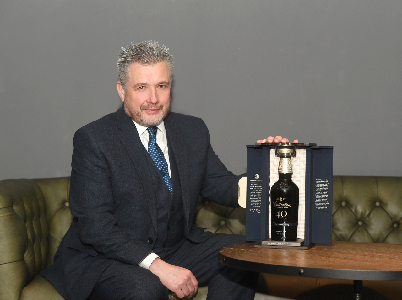 Sandy Hyslop, the master blender at Ballantine’s, poses for a picture next to one of the six bottles of the whisky producer’s new 40-year-old expression, 
