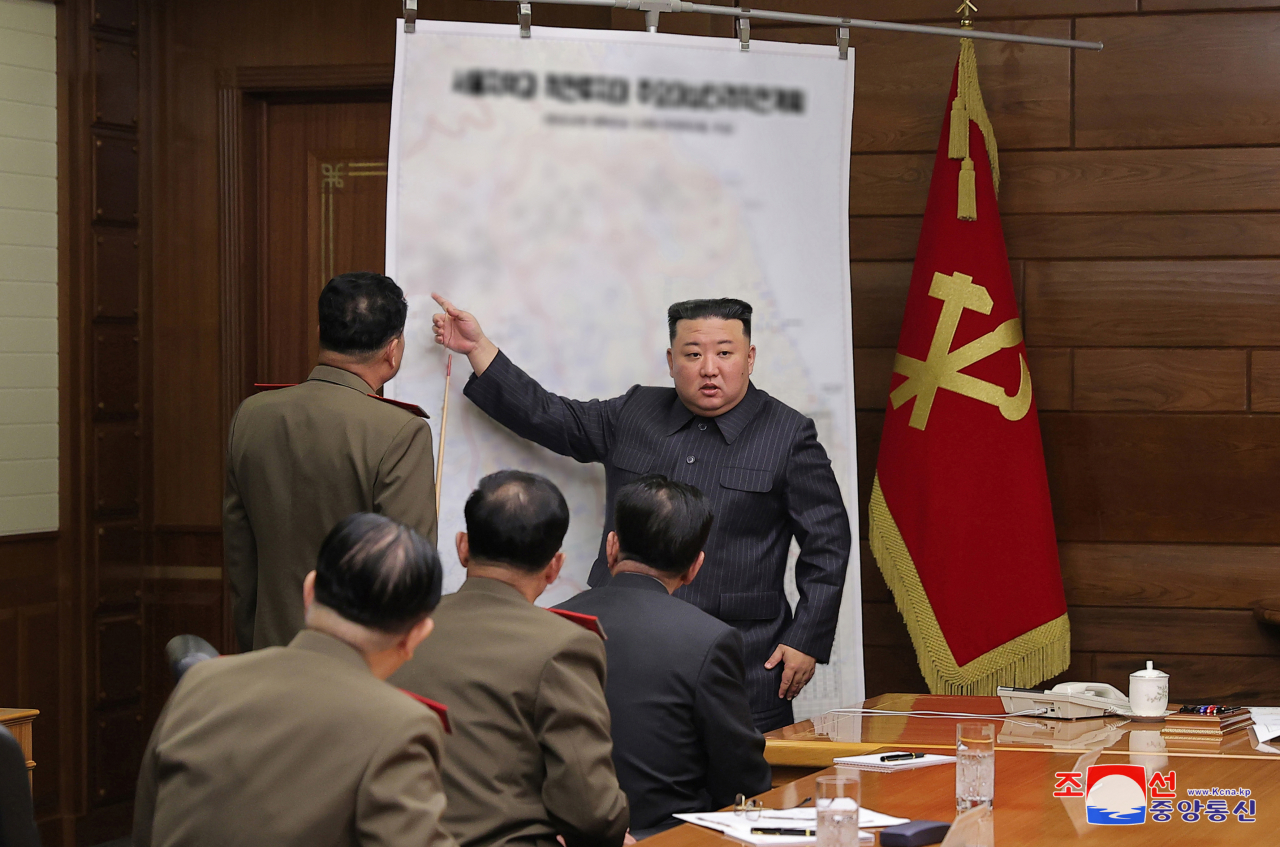 North Korean leader Kim Jong-un (standing, right) speaks during a meeting of the central military commission of the ruling Workers' Party on April 10, 2023, in this photo provided by North Korea's state-run Korean Central News Agency.(Yonhap)