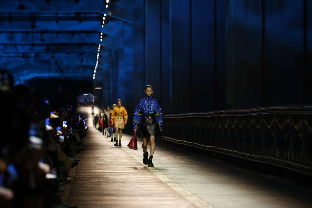 Models walk on Jamsu Bridge over the Han River in Seoul, which was turned into a runway for the Louis Vuitton pre-fall fashion show on Saturday. (Louis Vuitton)