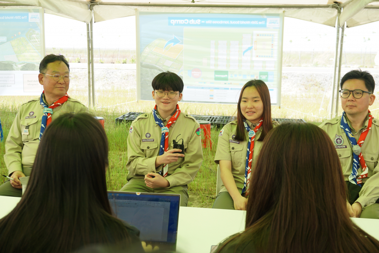 From left: Rhee Hang-bock, chief of the 25th World Scout Jamboree management team; Buan High School student Ahn Ye-sung; Nangju Middle School student Kim Ha-rang; and Jeong Seo-yong, chief of the Special Activity Program, answer reporters' questions at the Saemangeum Jamboree site on Thursday. (Ministry of Gender Equality and Family)